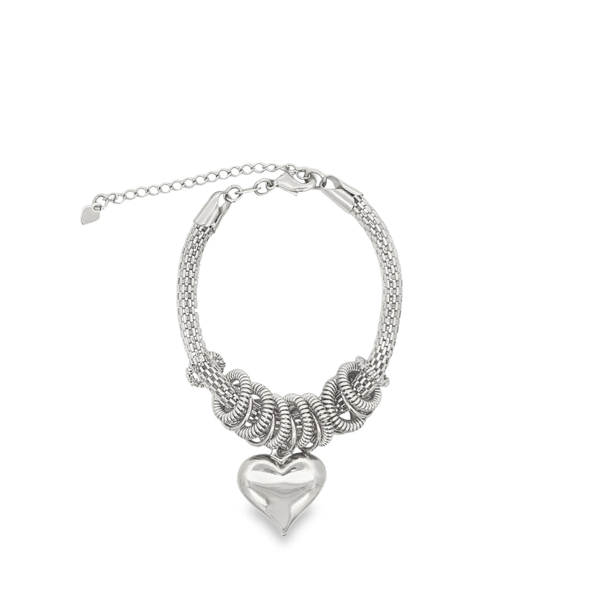A silver charm bracelet features a chunky mesh chain adorned with dangling coil rings and a large puffy heart pendant against a white background.