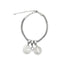 A silver mesh charm bracelet features two round religious medals and a sparkling gemstone pendant against a plain white background.