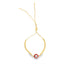 A delicate gold bolo bracelet features a red and white evil eye charm against a plain white background.