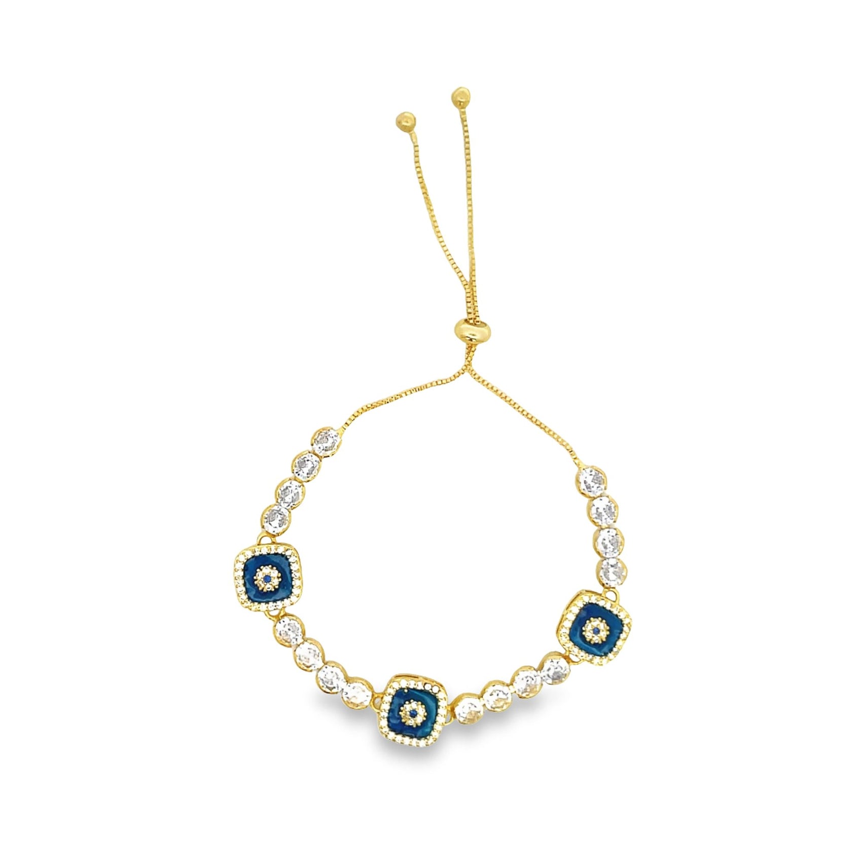 A gold bolo bracelet features alternating sparkling cubic zirconia stones and square blue enamel evil eye charms.