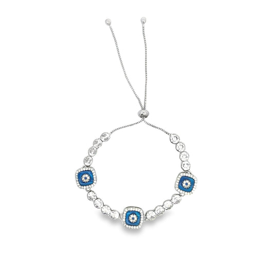 A silver adjustable sliding bolo bracelet features sparkling cubic zirconia crystals and three square blue evil eye charms.