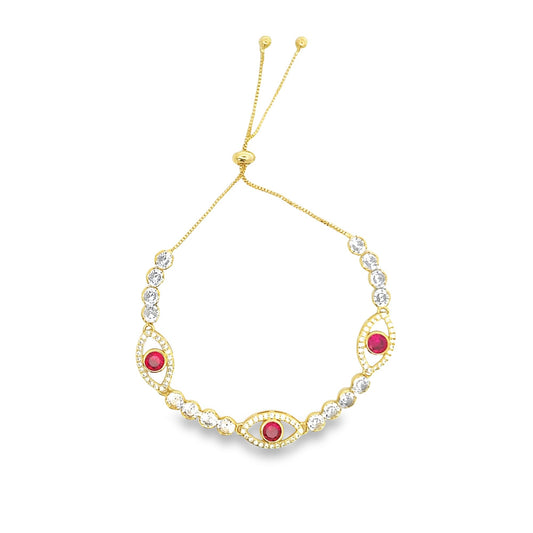 A gold bolo bracelet features three red and white evil eye charms alternating with sparkling cubic zirconia stones.