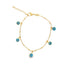 A delicate gold chain bracelet features multiple dangling blue evil eye charms against a white background.