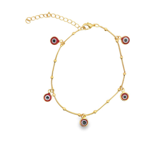 A delicate gold evil eye charm bracelet sparkles against a clean white background, showcasing dangling red protective amulets.