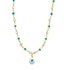 A gold chain necklace displays alternating blue-and-white evil eye charms and sparkling clear crystals, featuring a dangling evil eye pendant at the center.