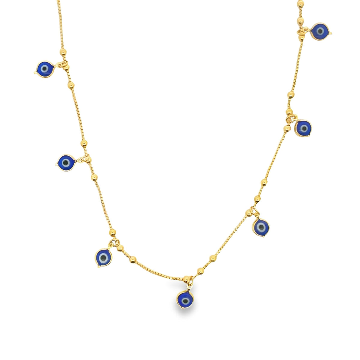 A delicate gold evil eye charm necklace displays multiple blue and white glass charms dangling from a beaded chain against a white background.