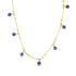 A delicate gold evil eye charm necklace displays multiple blue and white glass charms dangling from a beaded chain against a white background.