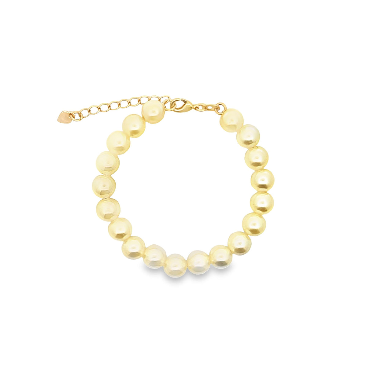 A delicate gold pearl bracelet rests on a clean white background, showcasing its glossy round pearls and adjustable chain clasp.