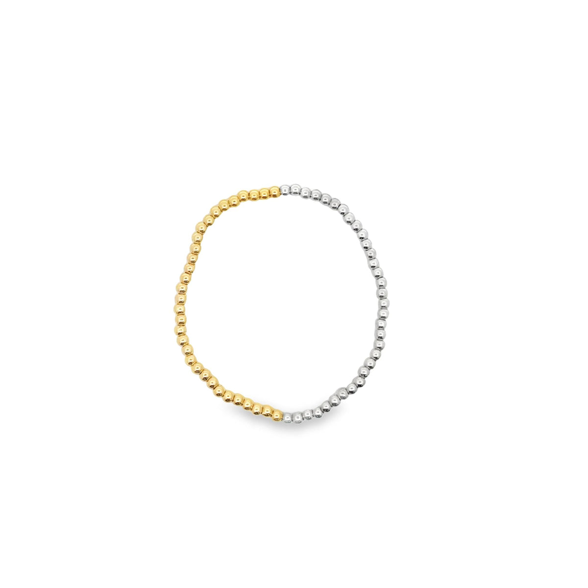 A delicate two-tone beaded ring features alternating sections of yellow gold and silver beads arranged in a continuous circle.