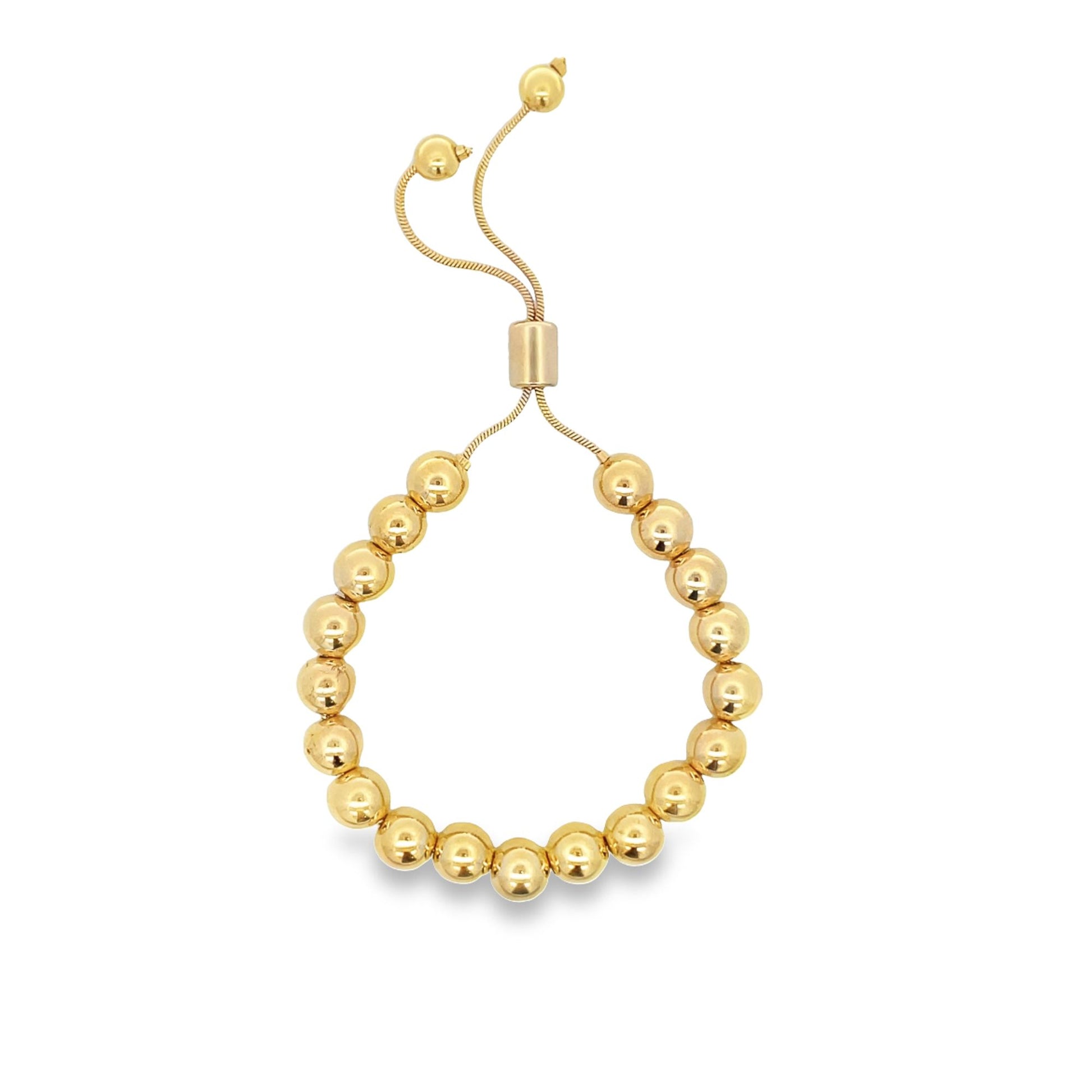 A gold bead bolo bracelet features a row of polished round metal spheres on an adjustable chain with sliding clasp closure.