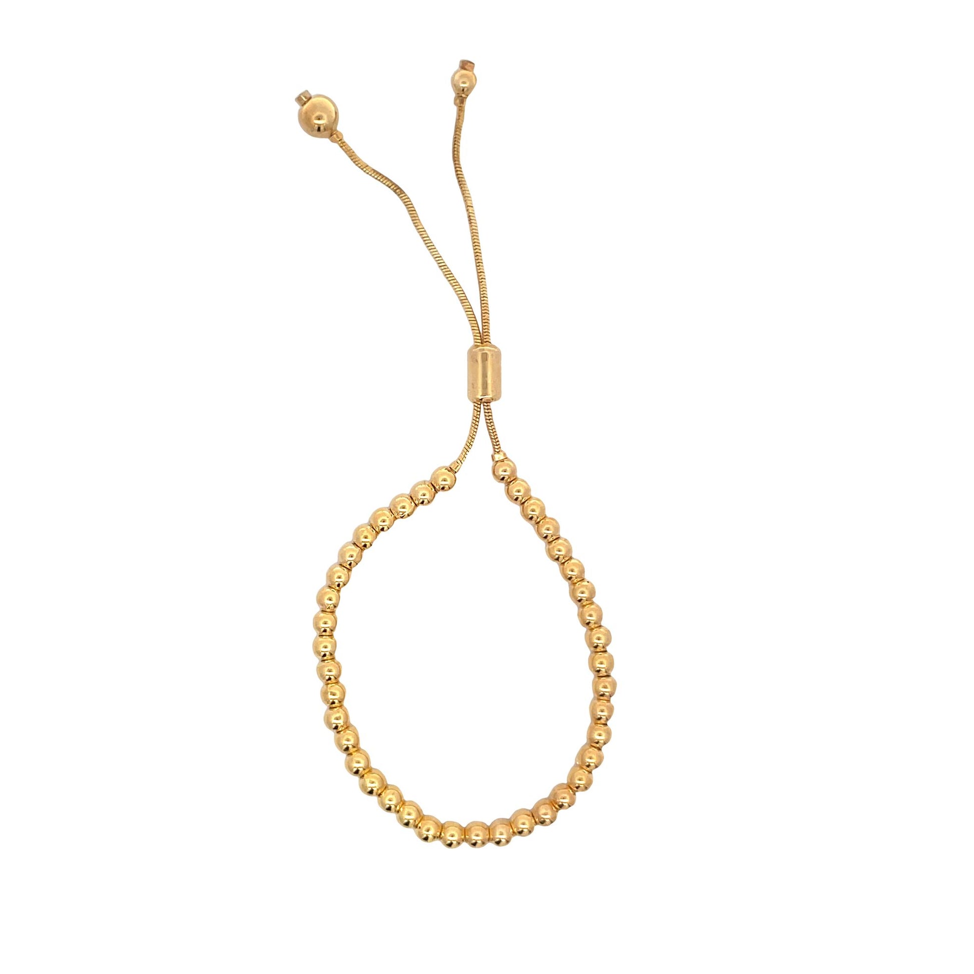 A gold bead slider bracelet features a continuous loop of polished round beads with adjustable hanging chains.