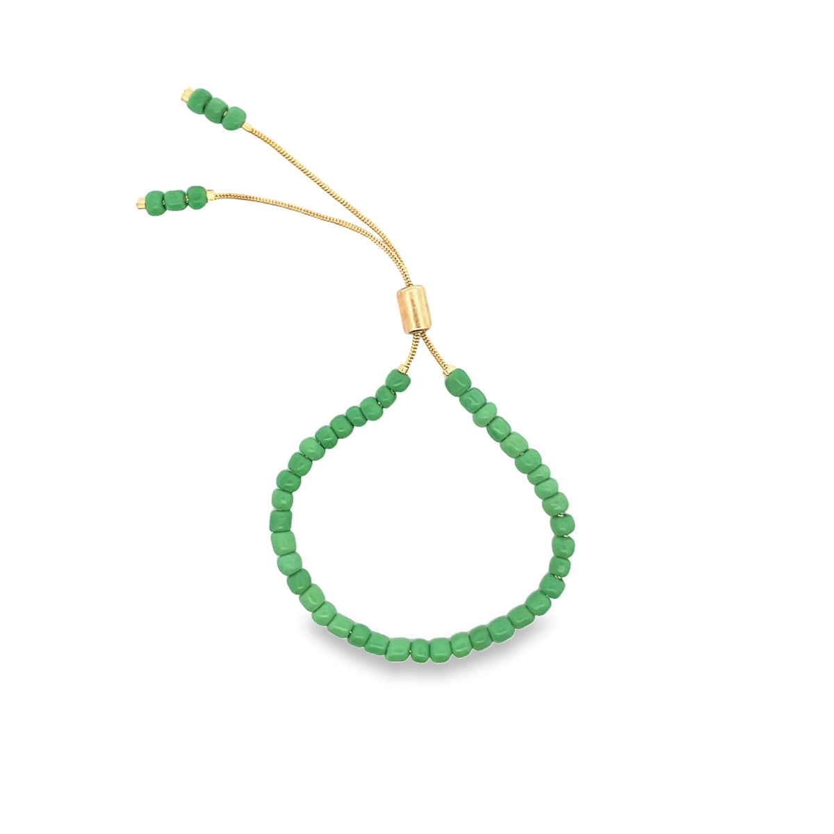 A delicate adjustable green beaded bracelet features a gold-tone slider clasp and dangling seed-bead ends against a clean white background.