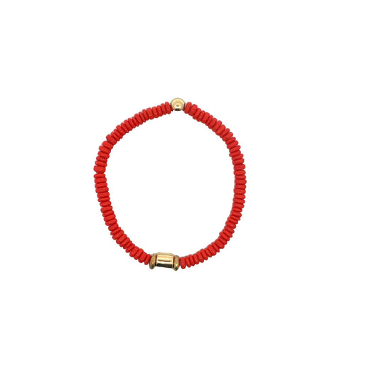 A vibrant red beaded stretch bracelet features a gold-tone accent bead against a clean white background.