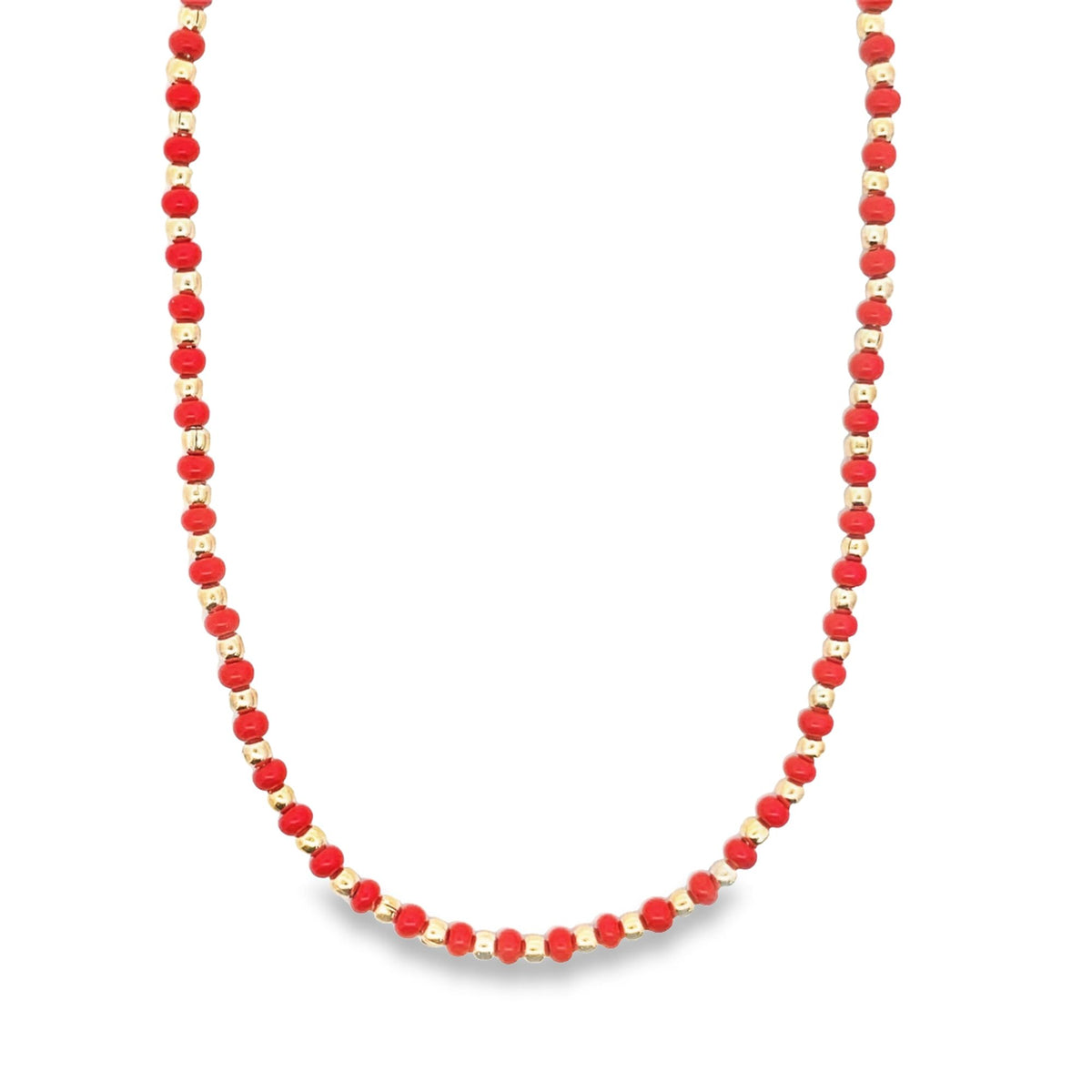 A vibrant red and gold beaded necklace rests against a clean white background.