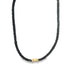 A black beaded necklace features a single gold accent piece centered at the bottom.