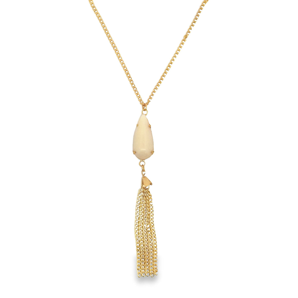 A gold chain necklace features a pear-shaped cream stone pendant with a delicate tassel dangling below.