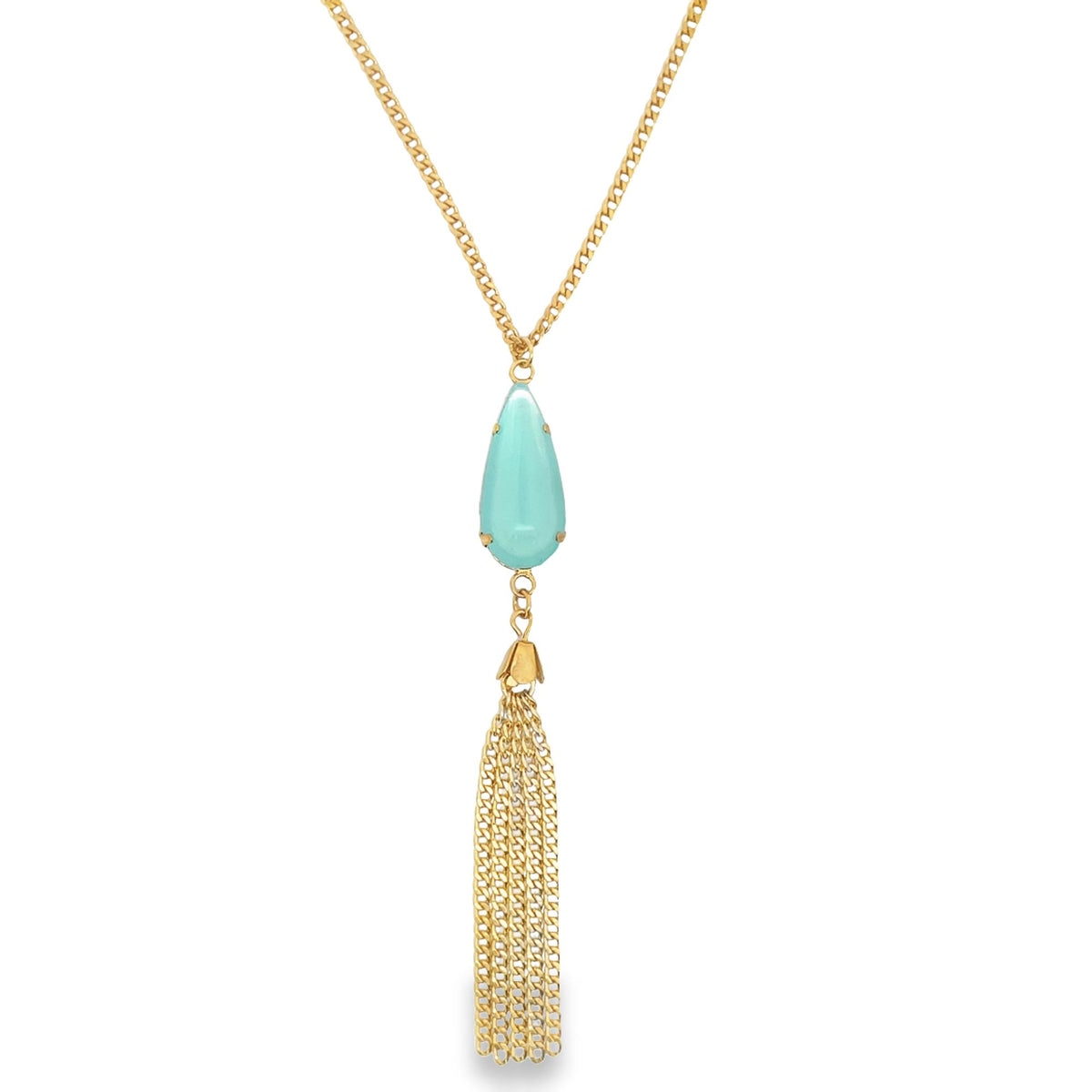 A gold chain necklace displays a teardrop-shaped turquoise pendant hanging above a delicate gold tassel.