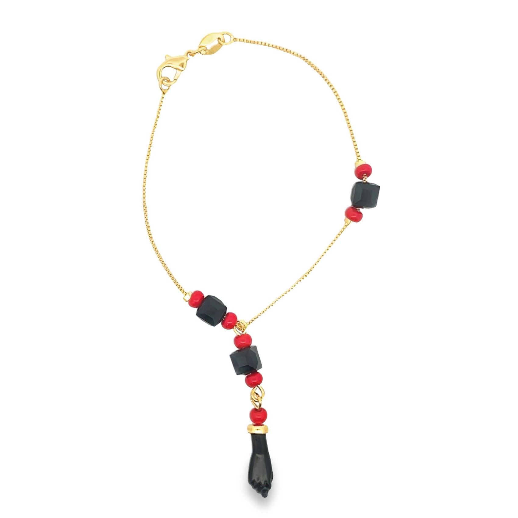 A gold chain bracelet features black and red beads, highlighted by a dangling figa fist charm.