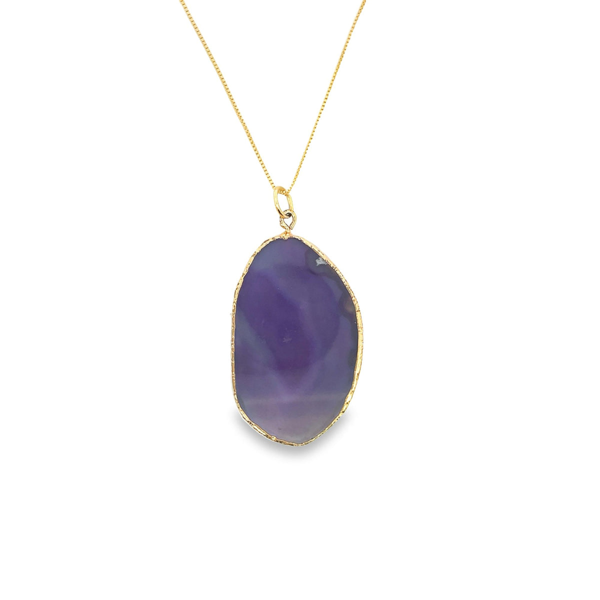 A delicate gold chain holds a striking purple agate pendant framed in gold against a plain white background.
