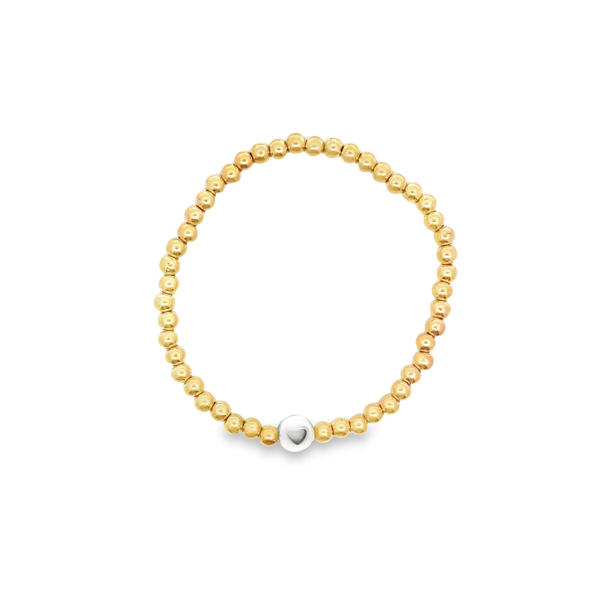 A gold beaded stretch bracelet features a central silver bead with an engraved heart.