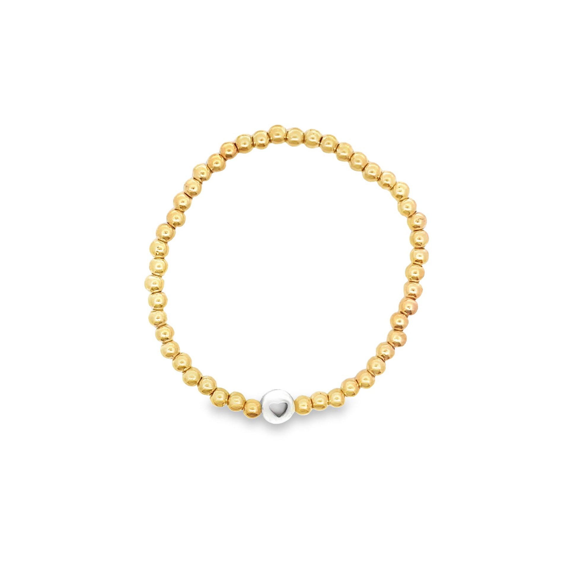 A gold beaded stretch bracelet features a central silver bead with an engraved heart.