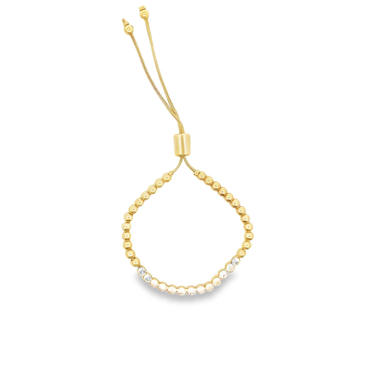 A gold bolo bracelet features a line of sparkling cubic zirconia stones along its beaded chain against a white background.