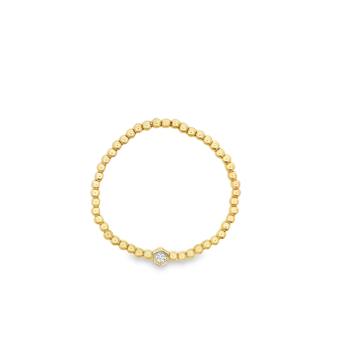 A delicate gold beaded ring features a sparkling hexagonal diamond accent at the center.