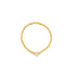 A delicate gold bead stretch ring features a small clover-shaped charm on a plain white background.