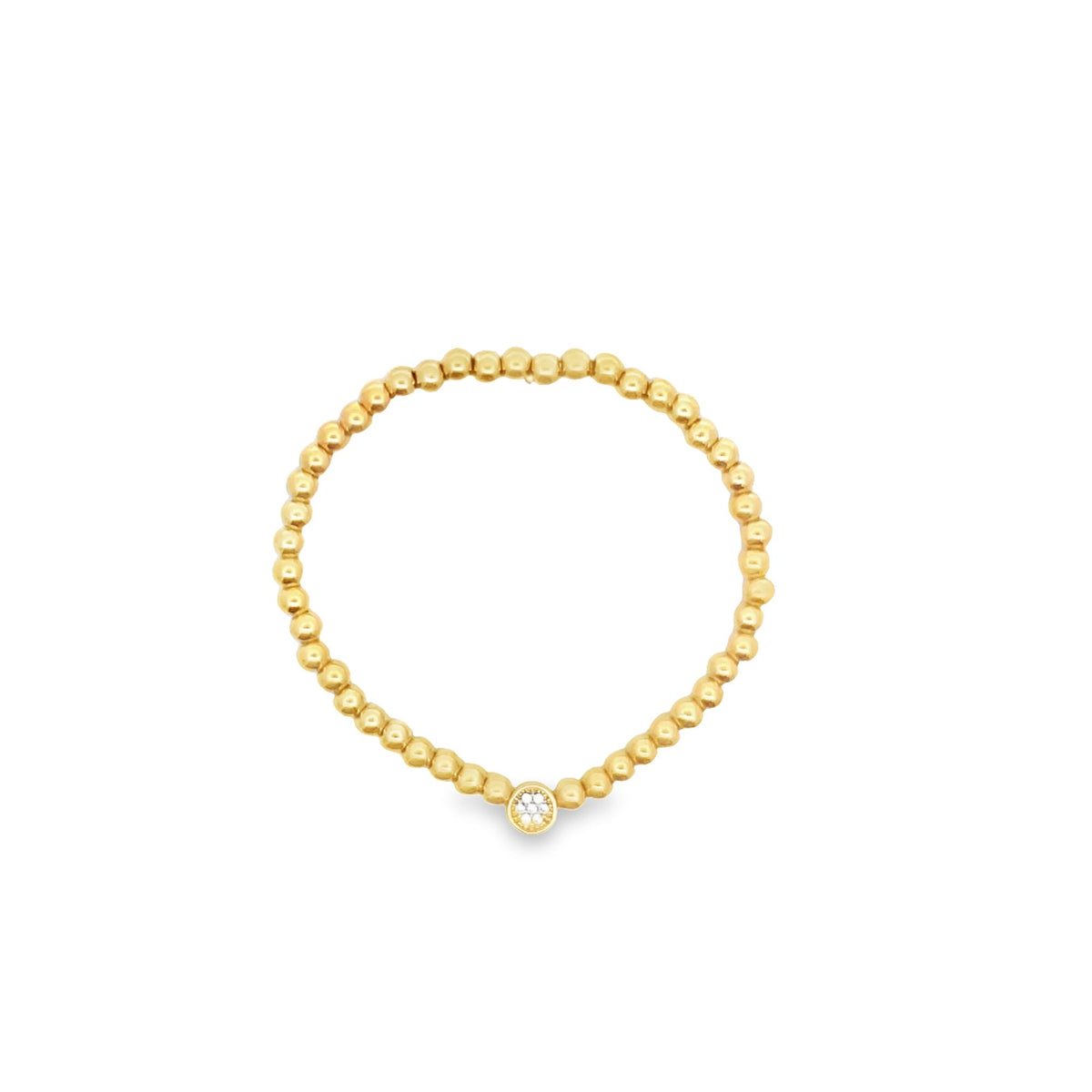 A delicate gold beaded stretch ring features a single diamond accent stone centered at the bottom against a clean white background.