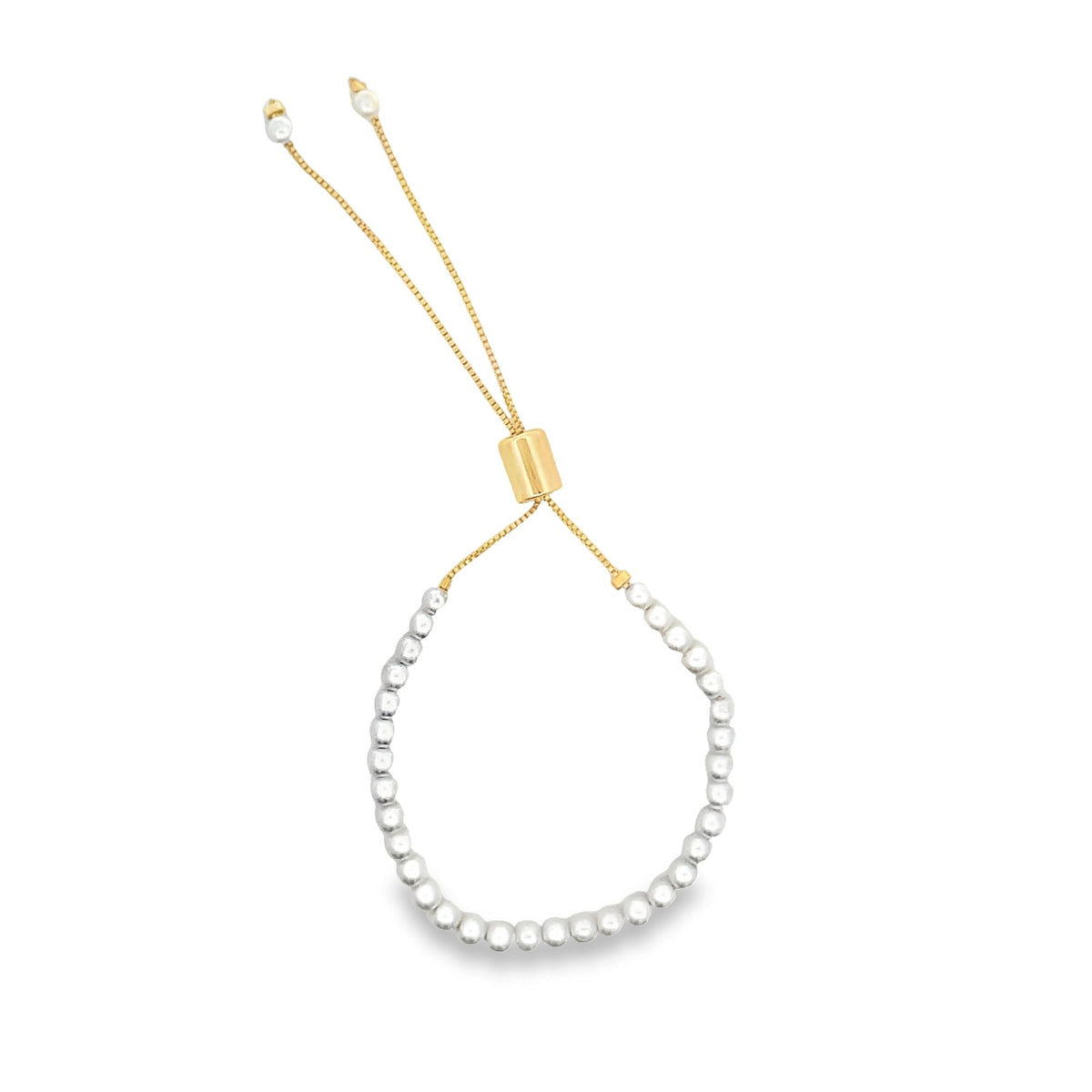 A delicate gold adjustable bolo bracelet features a semi-circle of small silver beads and hanging chains tipped with tiny pearls.