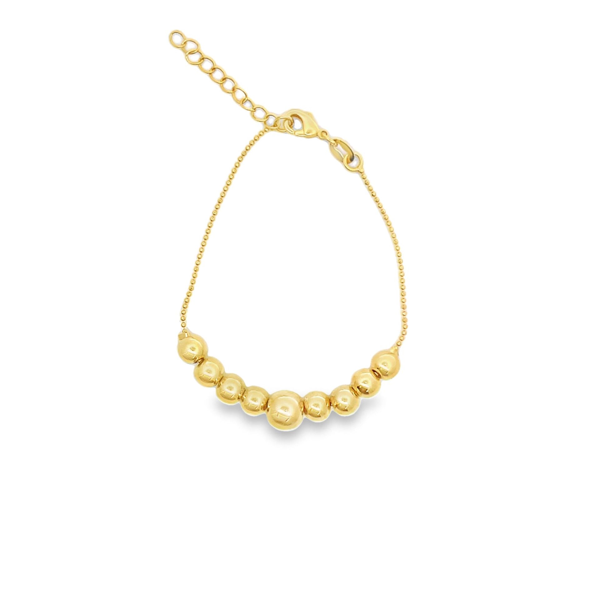 A delicate gold bead bracelet displays graduated spheres on a fine chain against a white background.