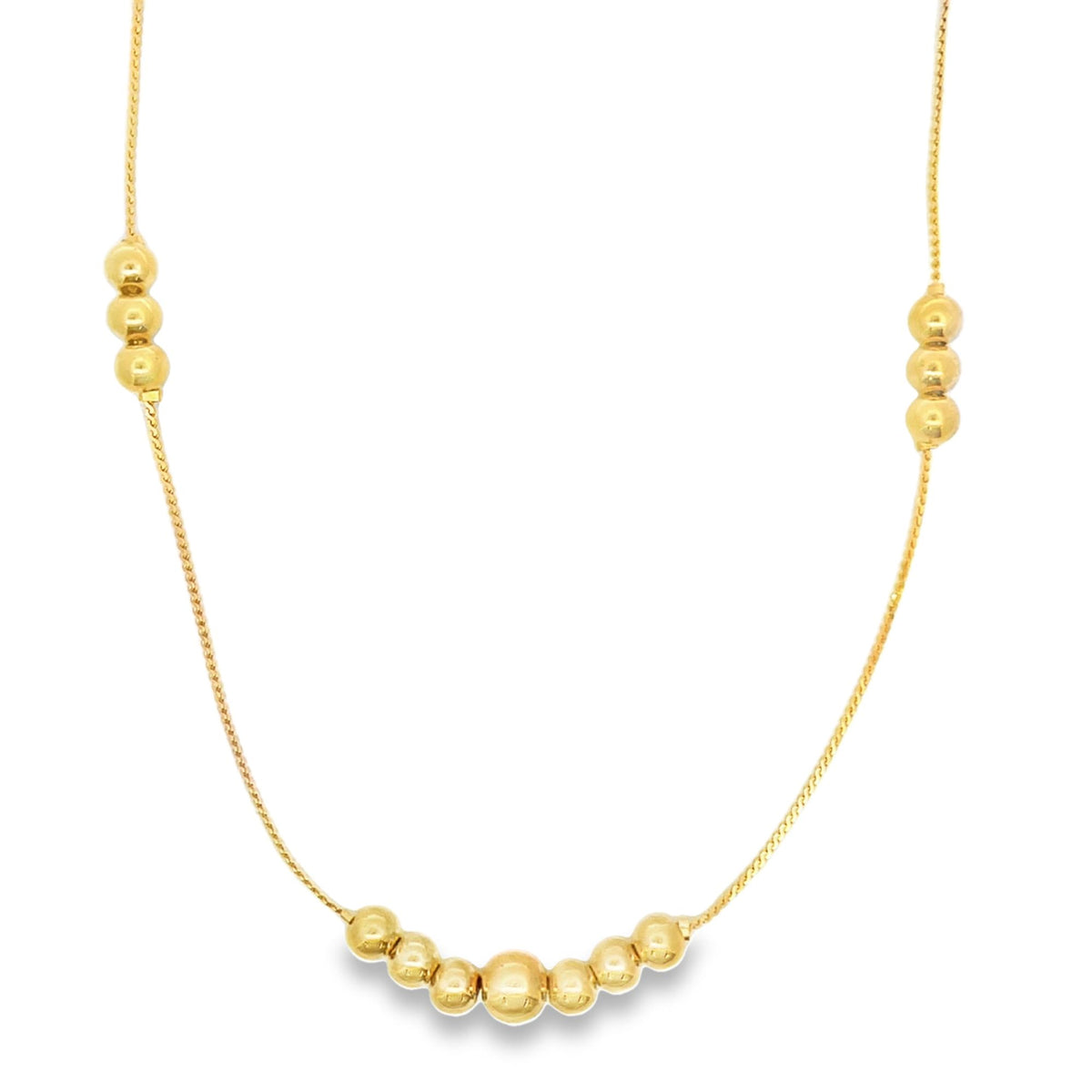 A delicate gold chain necklace features clusters of polished bead accents along its length.