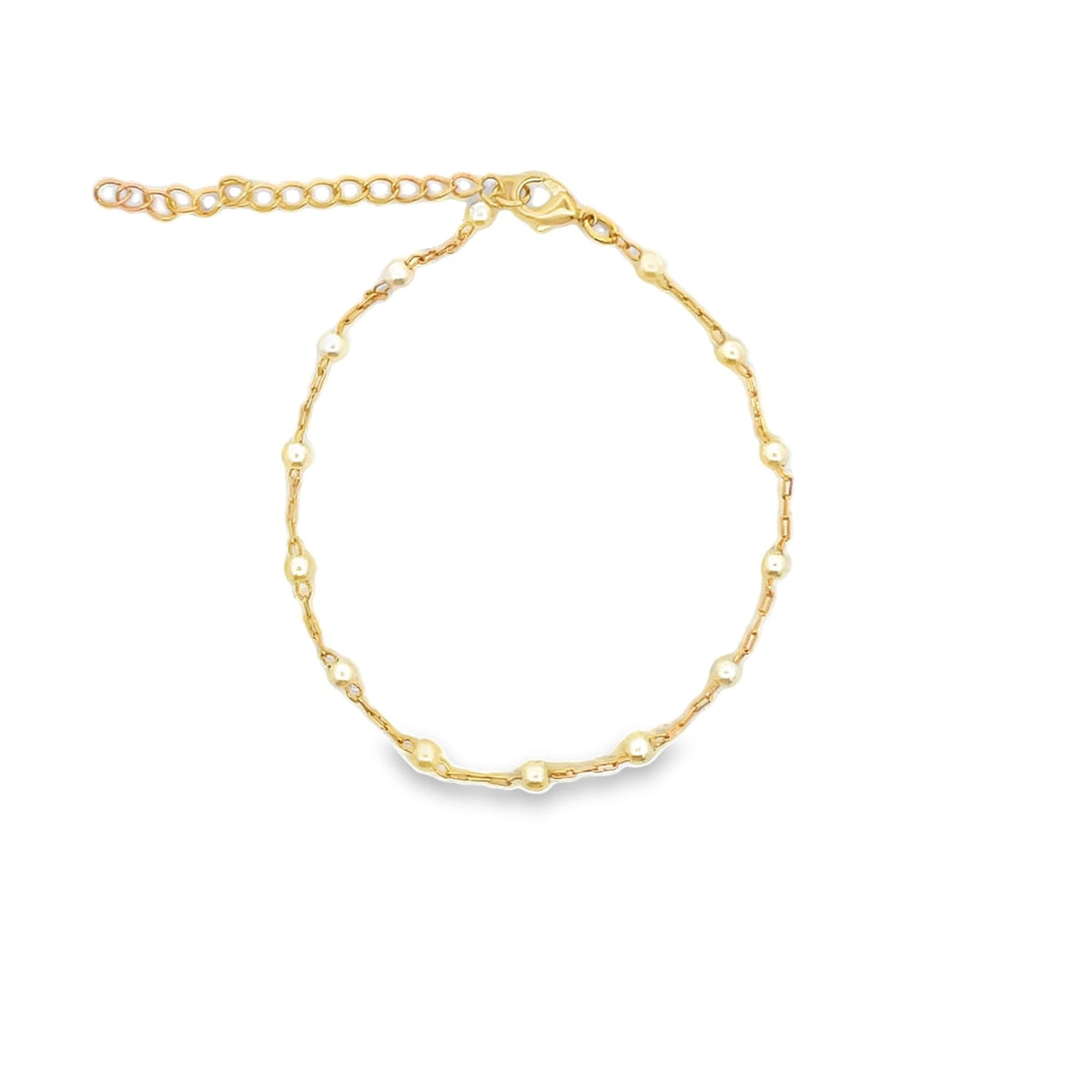 A delicate gold chain bracelet features evenly spaced shiny beads and an adjustable extender clasp.