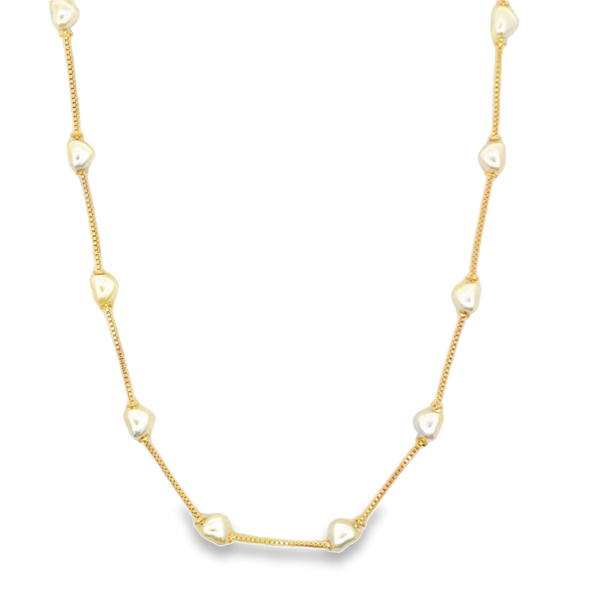 A delicate gold chain necklace features evenly spaced pearl accents against a plain white background.