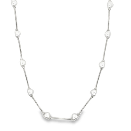 A delicate silver chain necklace features evenly spaced, small heart-shaped beads along its length.