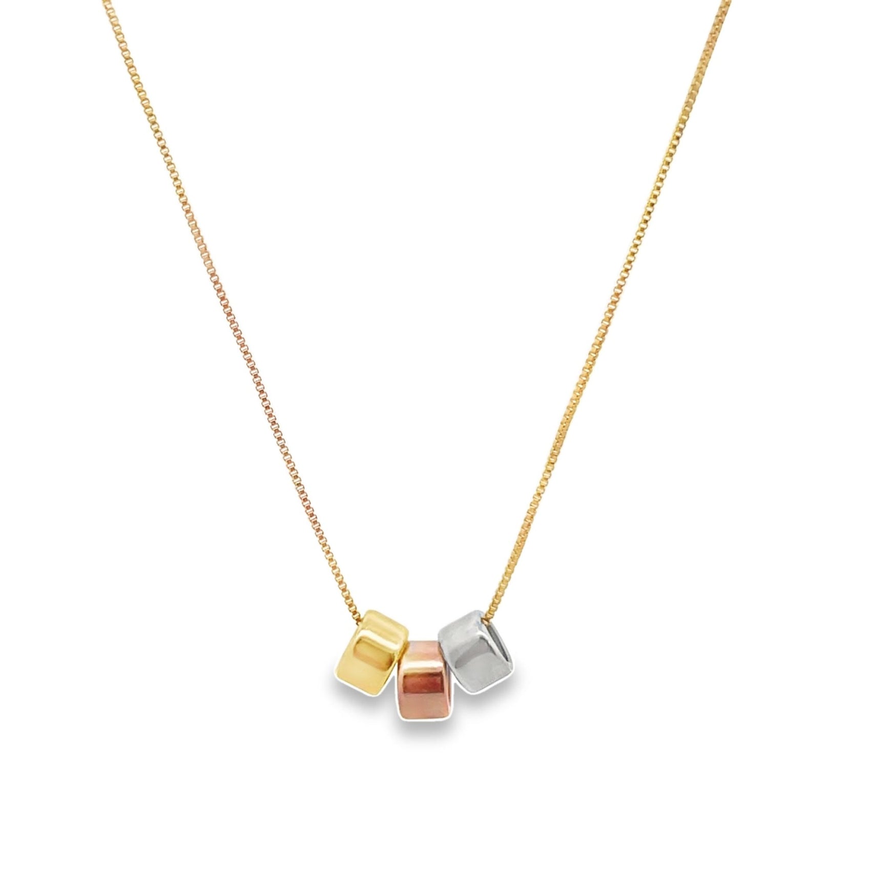 A delicate gold chain necklace dangles three interlocking cube charms in yellow, rose, and white gold.
