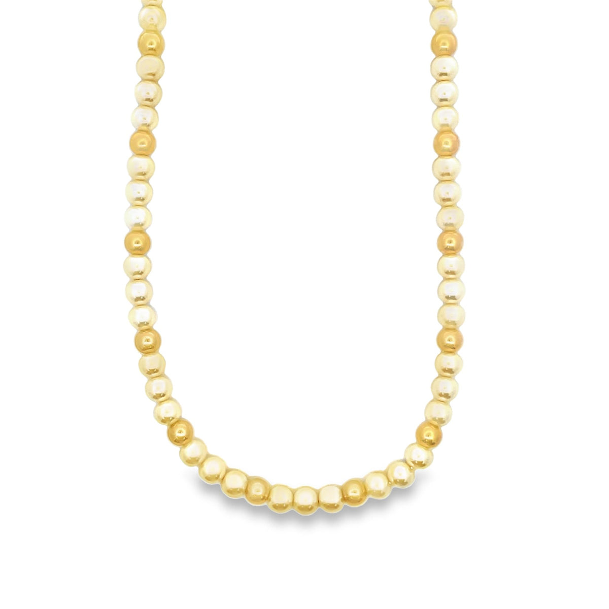 A shiny gold bead necklace drapes gracefully against a plain white background.