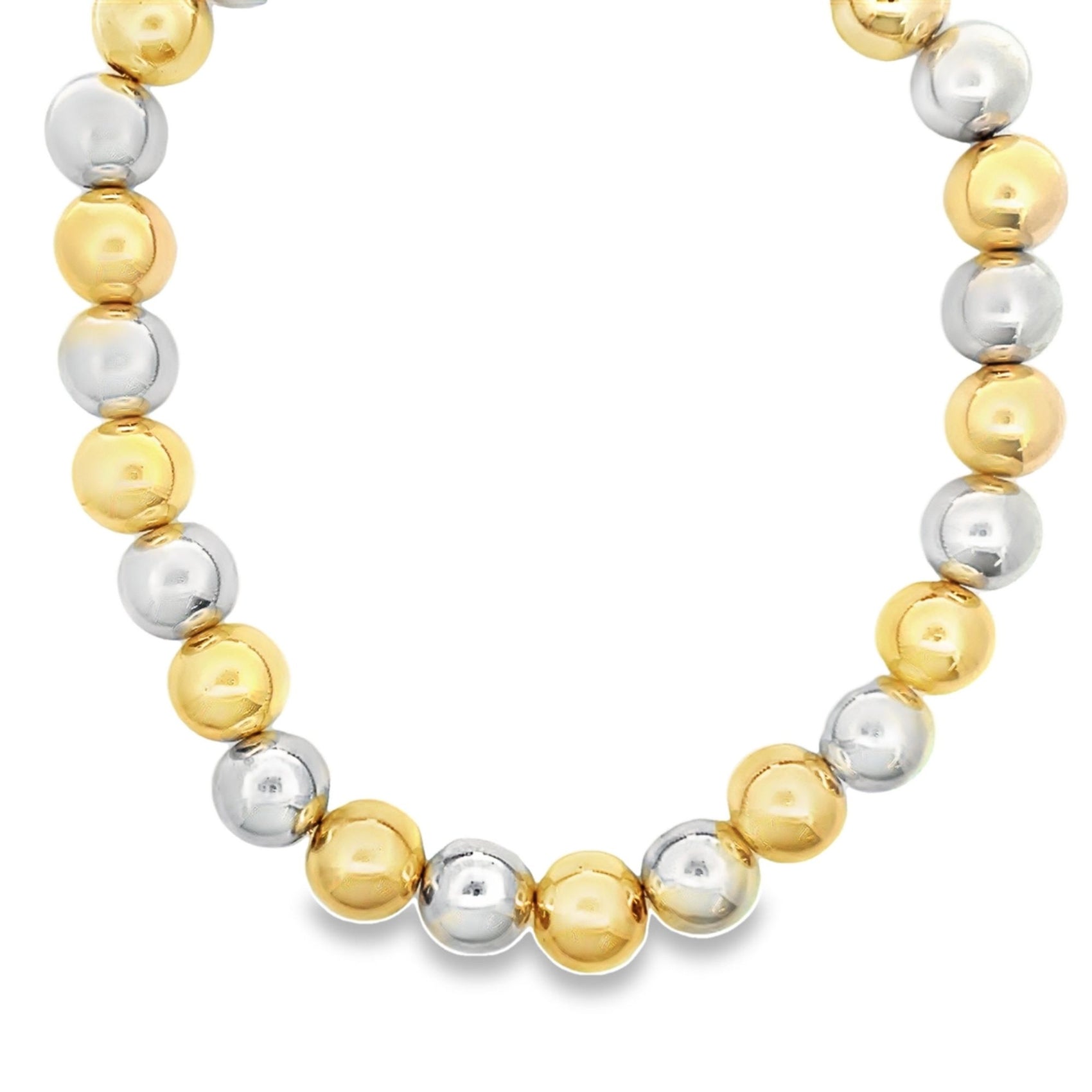 A beaded necklace features alternating polished yellow gold and silver spheres arranged in a curved line against a white background.