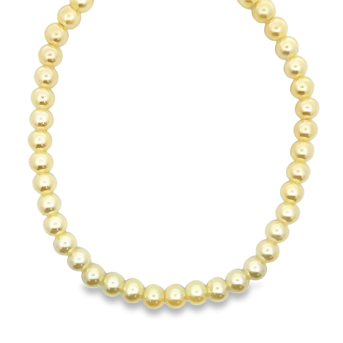 A continuous strand of shiny gold spherical beads forms a circular necklace against a plain white background.