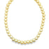 A shiny gold bead necklace curves gracefully against a clean white background.