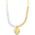 A two-tone beaded necklace features silver beads on the left and gold beads on the right, centered with a polished gold heart pendant.