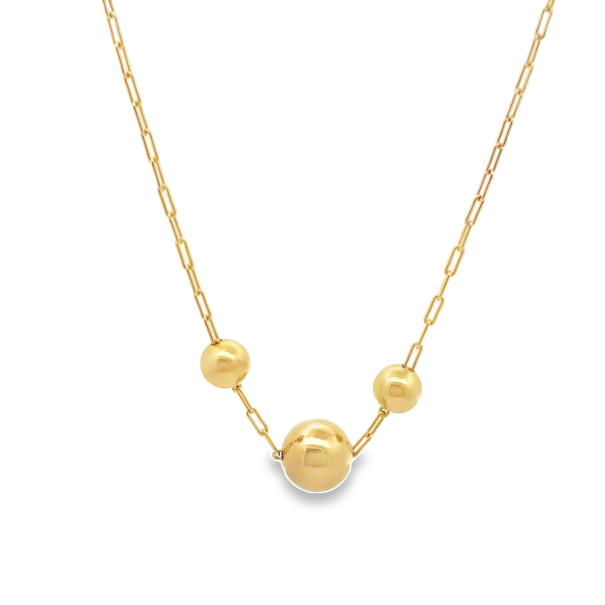 A delicate gold paperclip chain necklace features three polished bead charms suspended gracefully in the center.