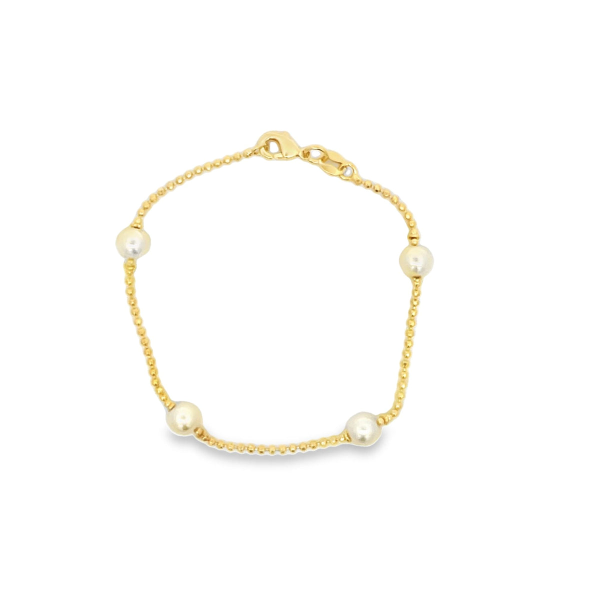 A delicate gold beaded bracelet features four evenly spaced white pearls and a secure clasp against a clean white background.
