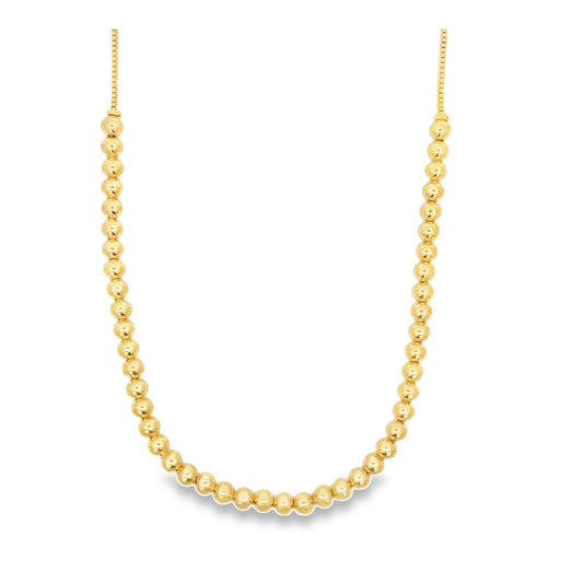 A gleaming gold bead necklace displays a uniform row of polished spherical beads linked together.