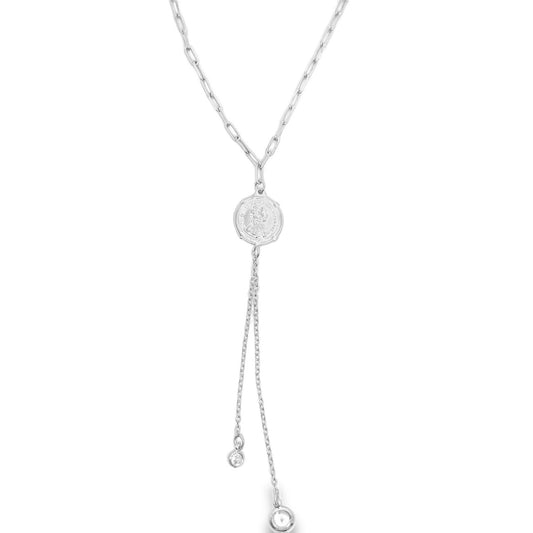 A silver lariat necklace features a delicate paperclip chain leading to a coin pendant with two dangling chains ending in sparkly gems.
