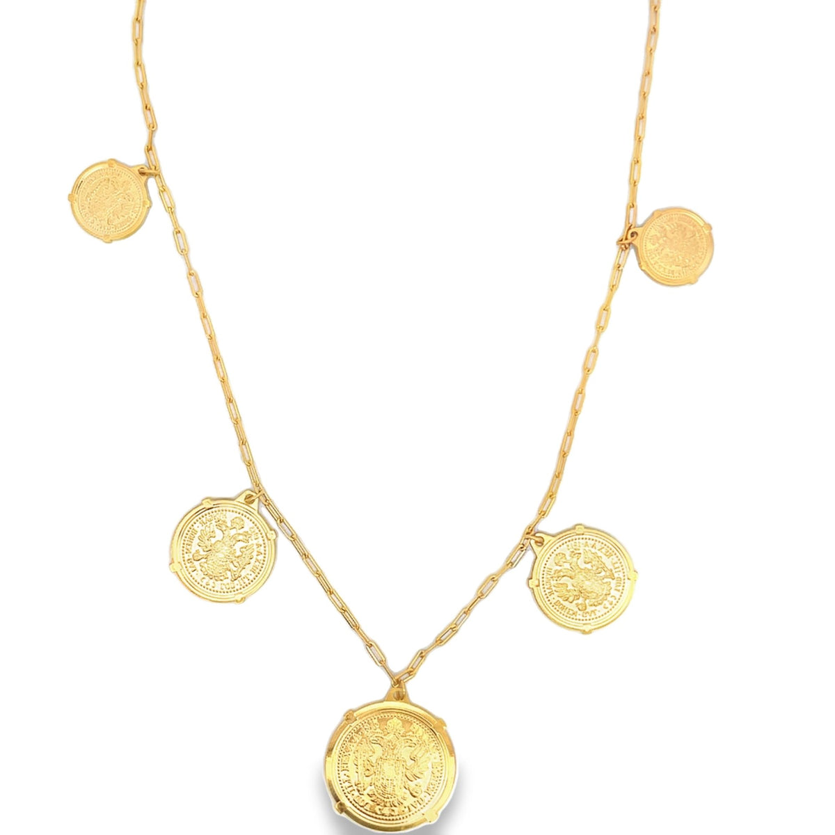 A delicate gold chain necklace dangles five ornate coin pendants against a white background.