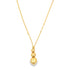 A delicate gold chain necklace features three graduated shiny spheres suspended as a pendant.