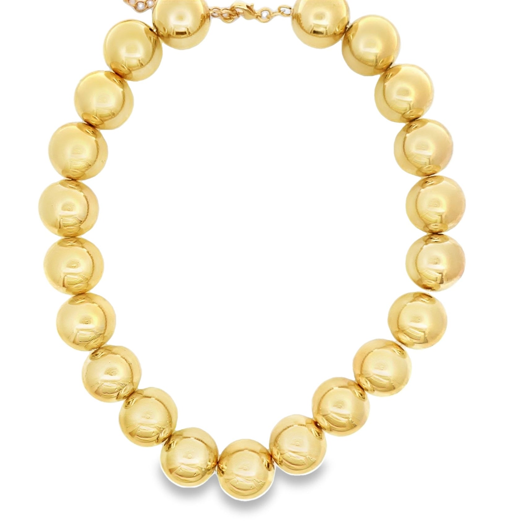 A bold, glossy gold bead statement necklace gleams against a clean white background.