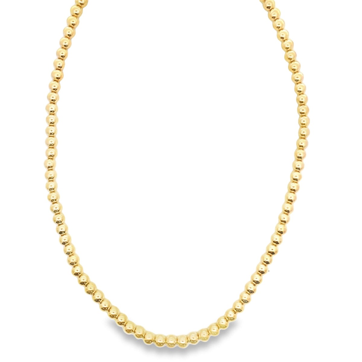 A classic yellow gold bead necklace drapes gracefully against a clean white background.