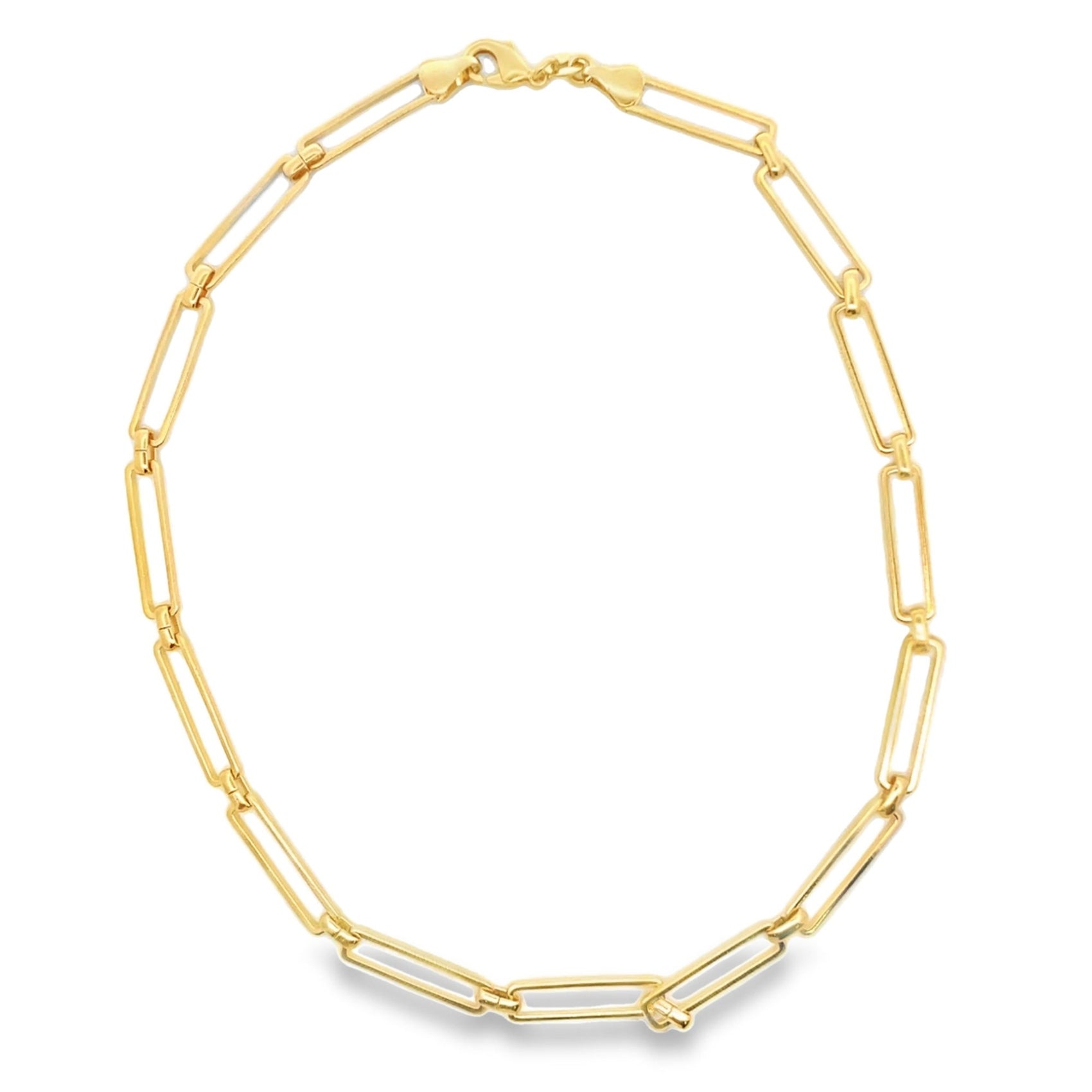 A shiny gold paperclip chain necklace rests on a plain white background.